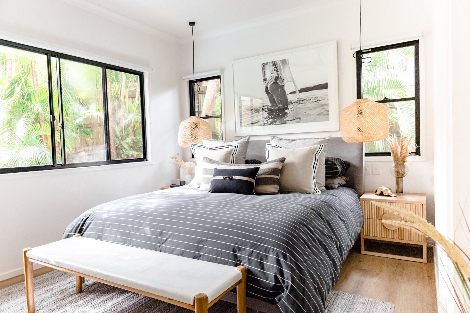 Master king bedroom with rattan pendant lights, tropical garden views and luxury coastal linen — LUXE Noosa Heads holiday accommodation