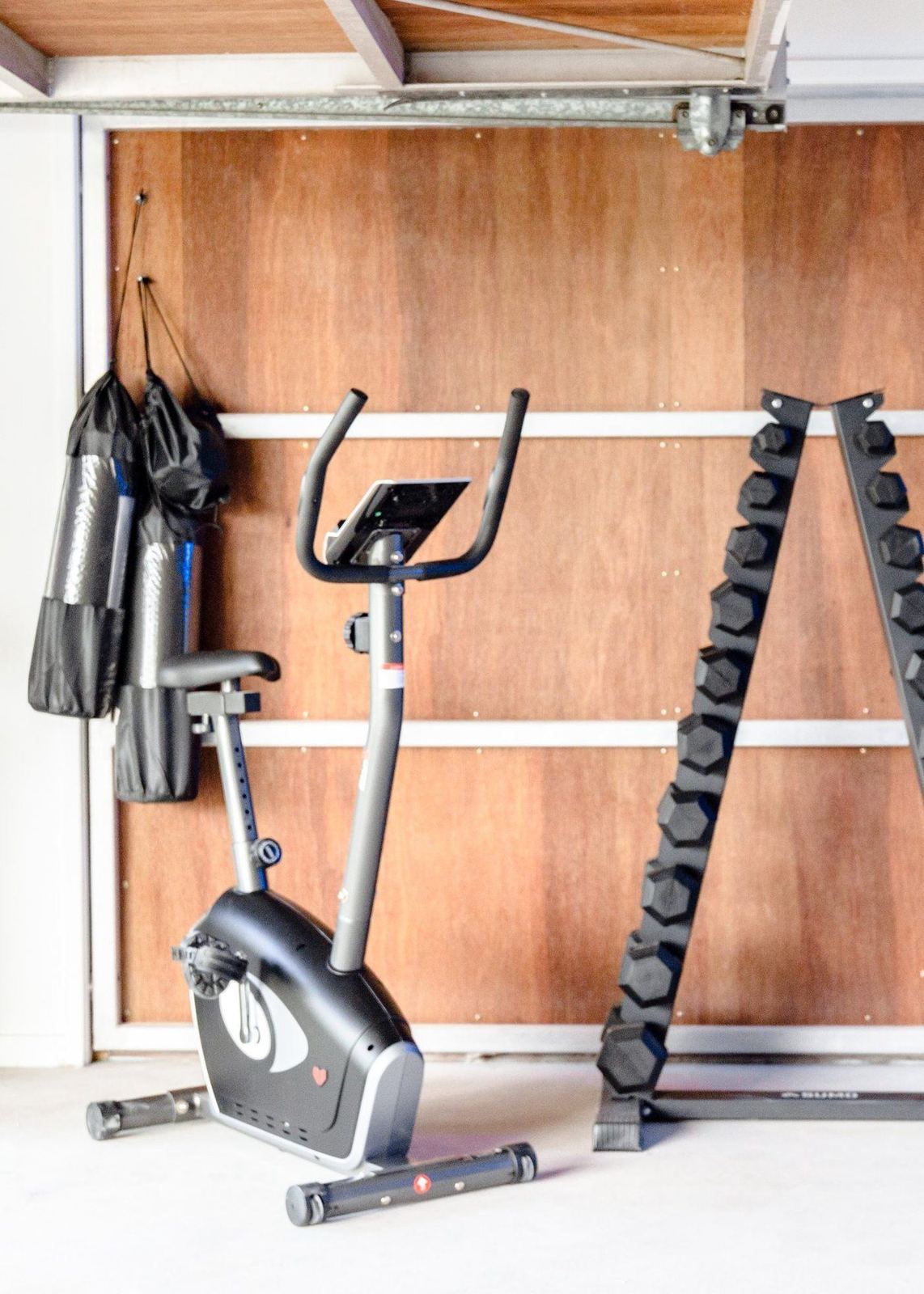 Gym equipment including exercise bike and dumbbells at LUXE Noosa