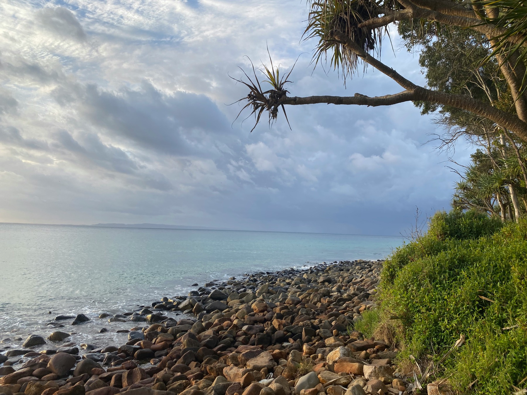 Clouds gathering over a rocky Noosa coastline