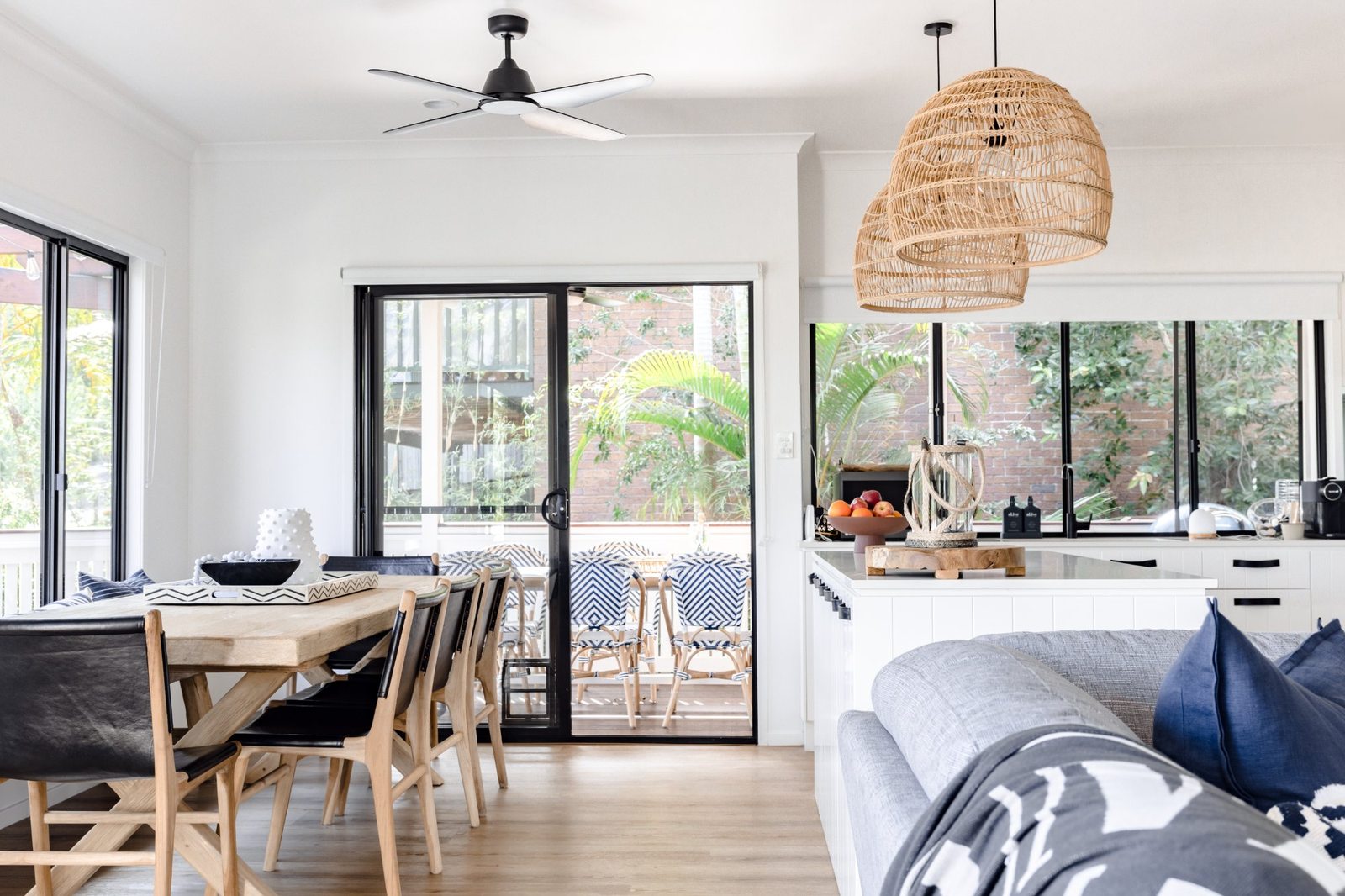 Open-plan living and dining area with balcony outlook at LUXE Noosa Hill