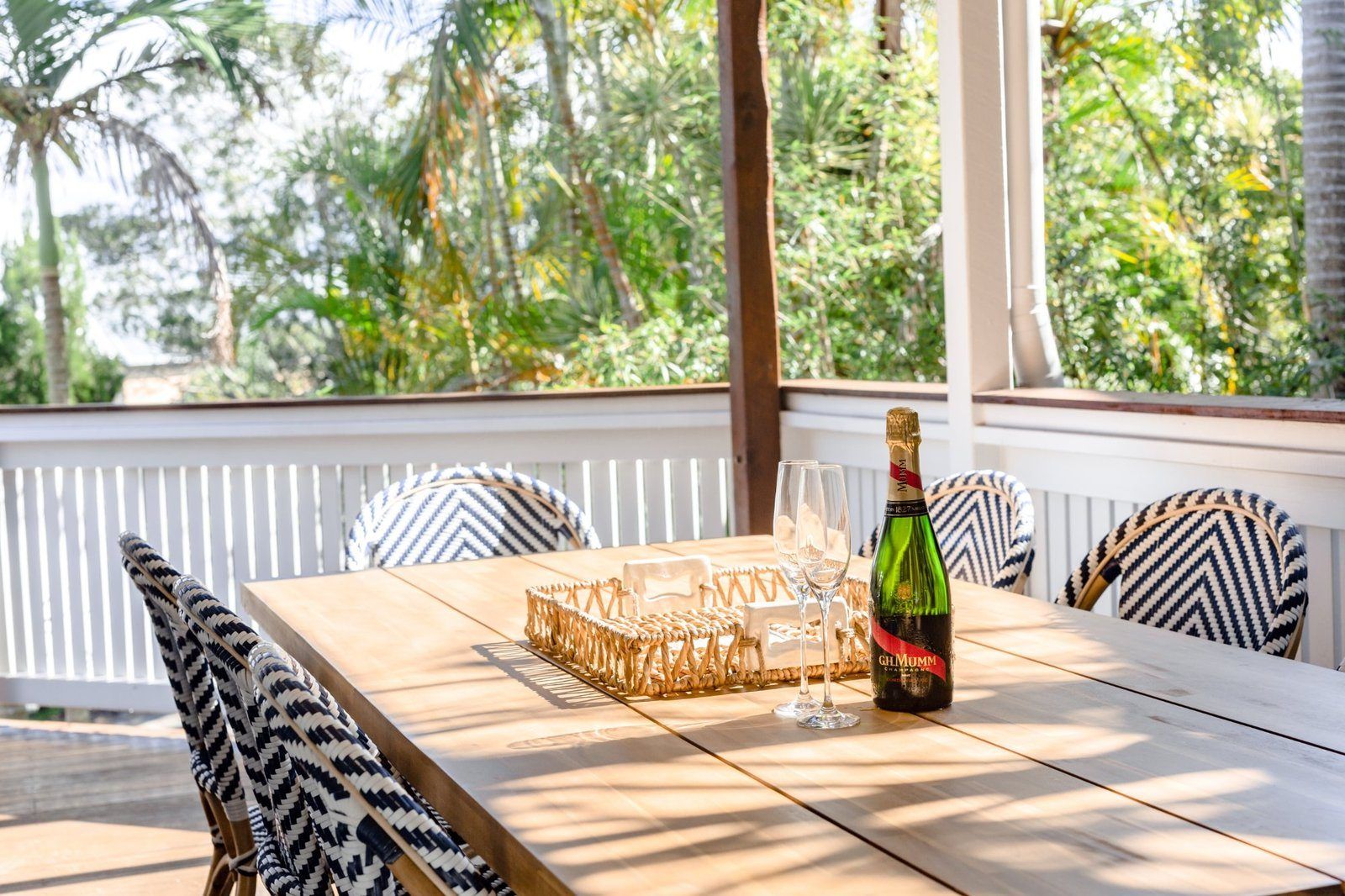 Elevated balcony dining overlooking hinterland at LUXE Noosa — holiday home Noosa Hill Queensland