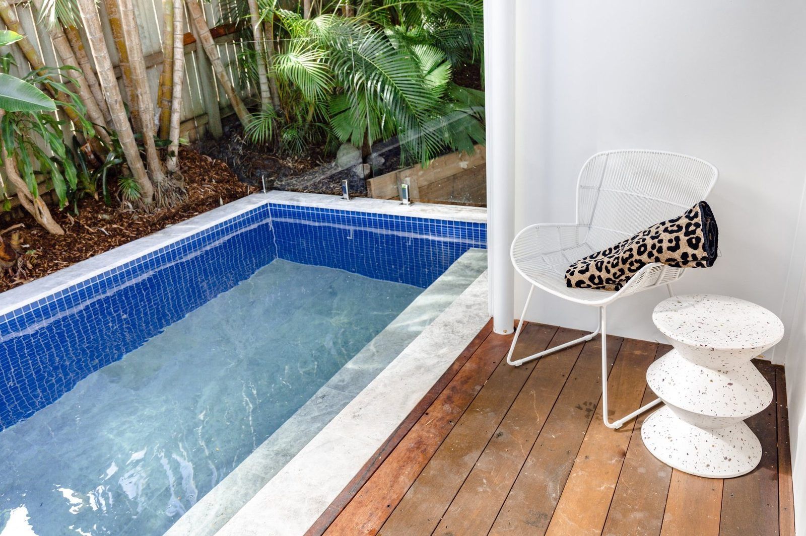 Heated pool with blue mosaic tiles and timber deck at LUXE Noosa — Noosa Hill holiday home
