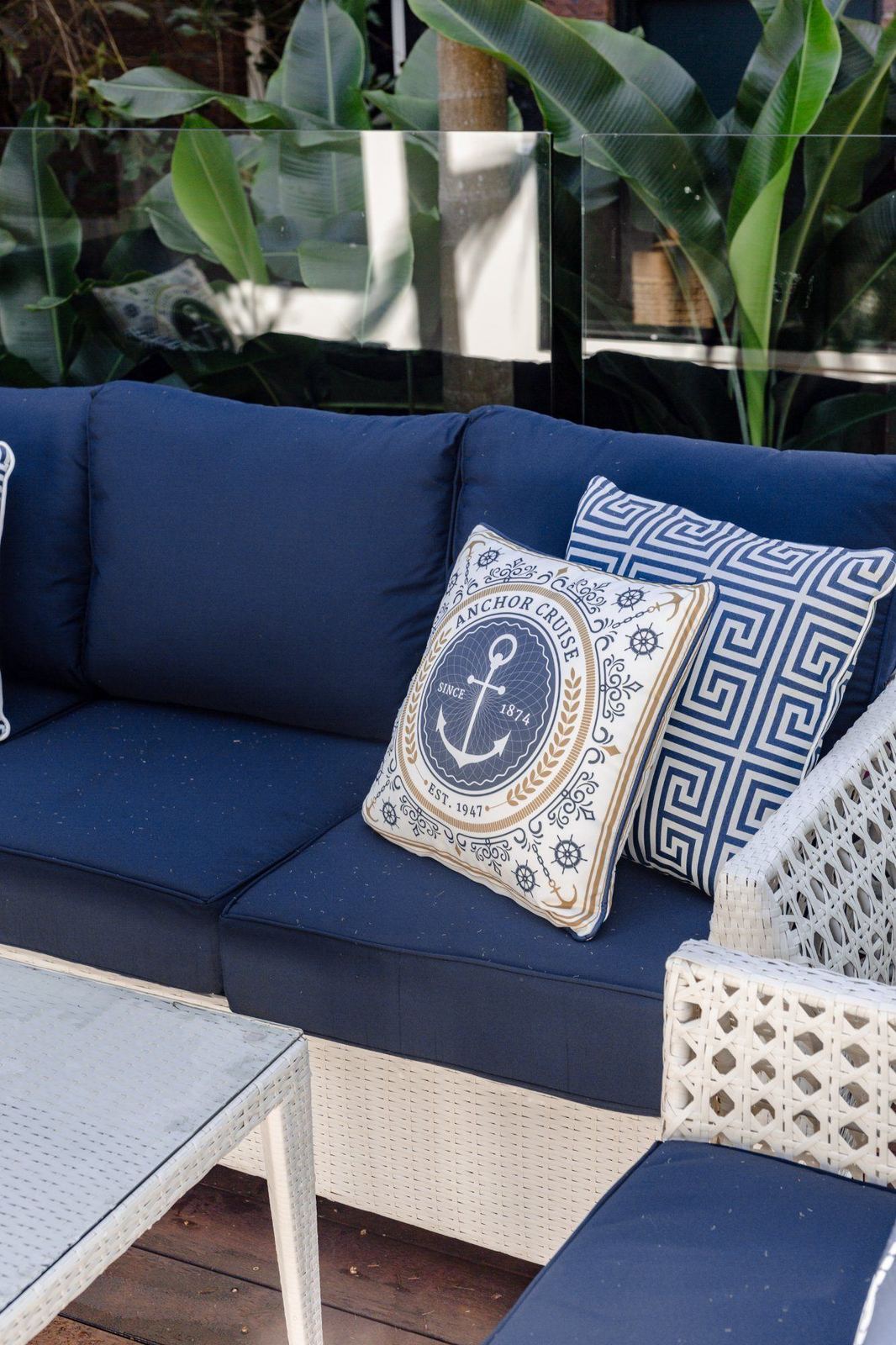 Navy pool loungers beside tropical planting at LUXE Noosa Hill